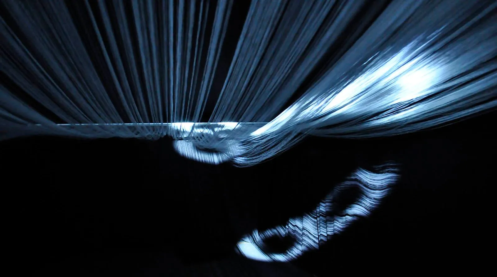 Misty Way: fog droplets filmed at high magnification, projected as light onto a ceiling of stretched threads